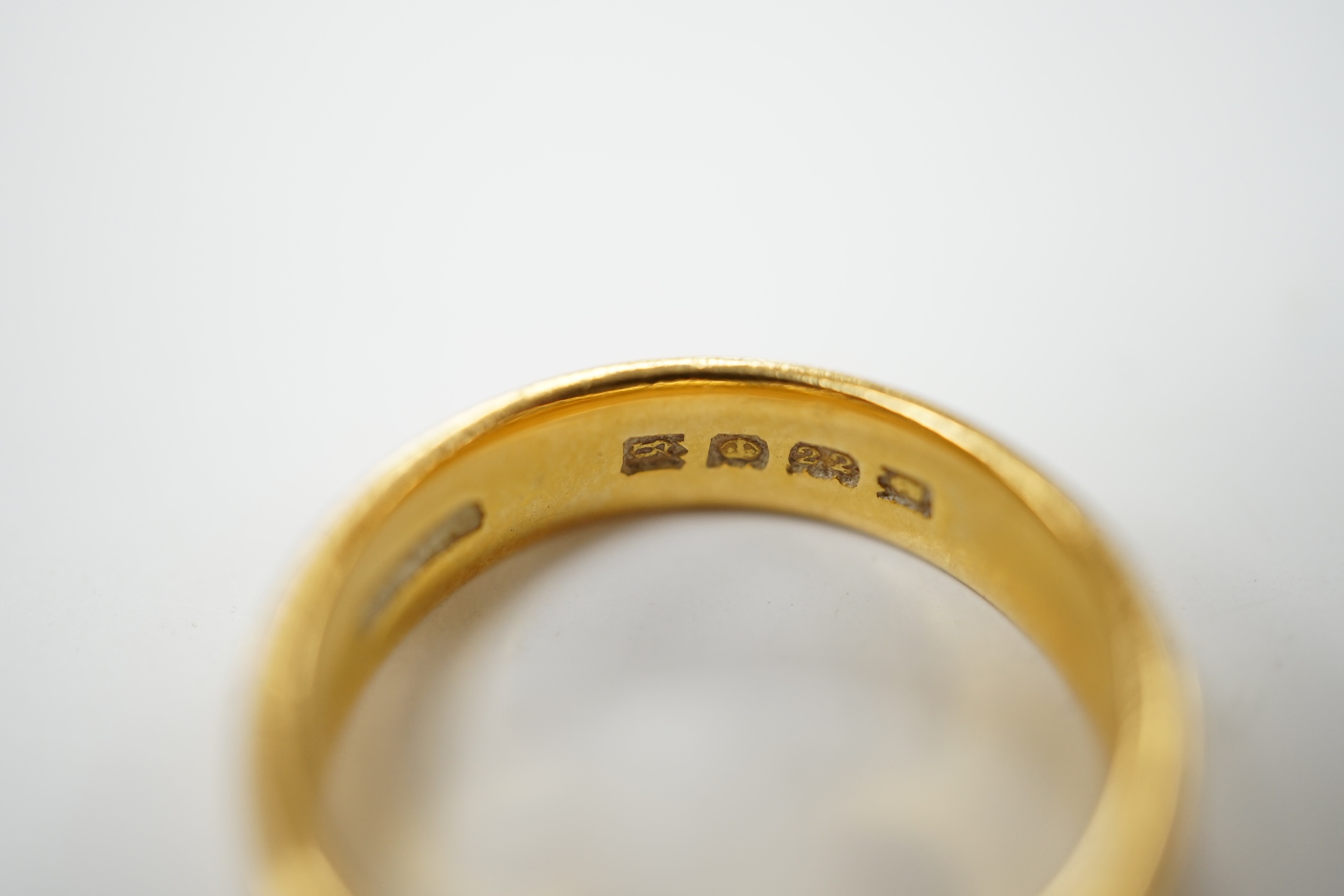 A George V 22ct gold wedding band, size K, 5.5 grams. Condition - fair